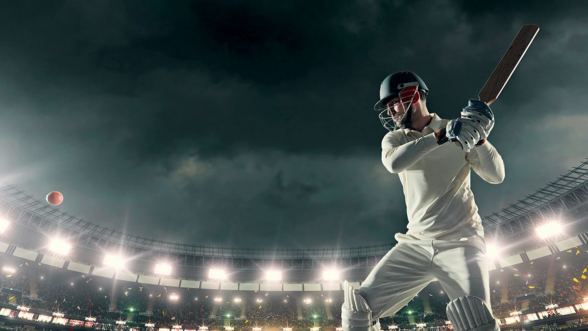 A cricket player hitting a ball for six runs.